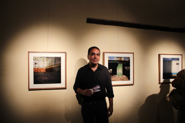 Fernando Di Sisto in front of his photographs at his opening