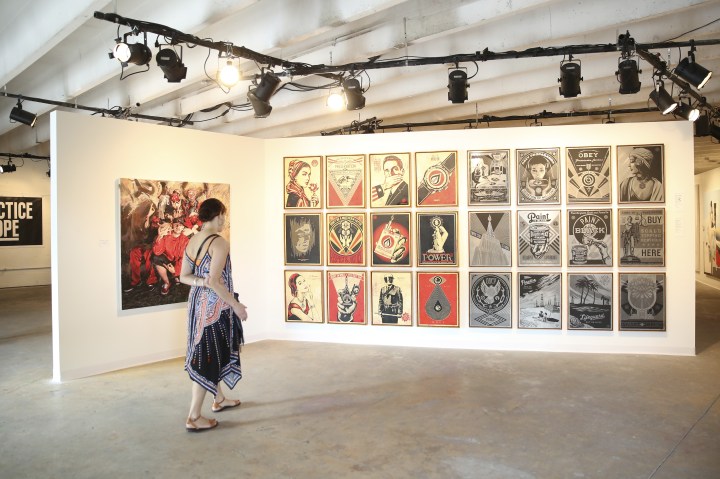 MIAMI, FL - DECEMBER 03: An attendee views artwork at The Dean Collection X BACARDI No Commission Art Fair Day 1 on December 3, 2015 in Miami, Florida. (Photo by Monica Schipper/Getty Images for Bacardi)